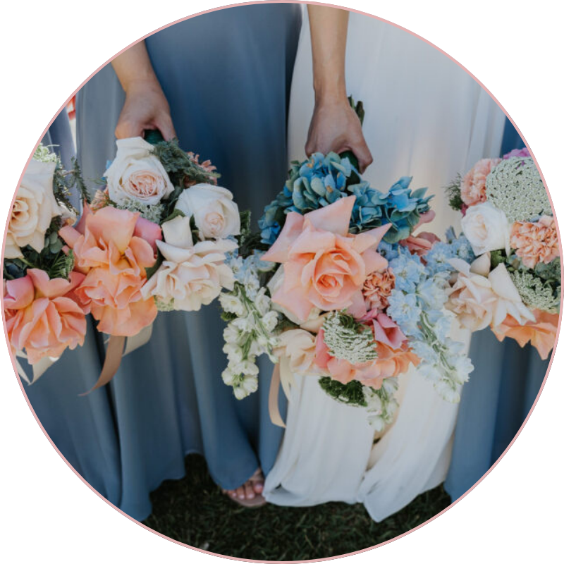 Bridesmaids holding pastel wedding bouquets with roses and hydrangeas